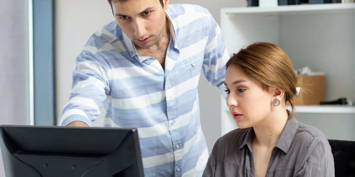 Coworker looking at a PC
