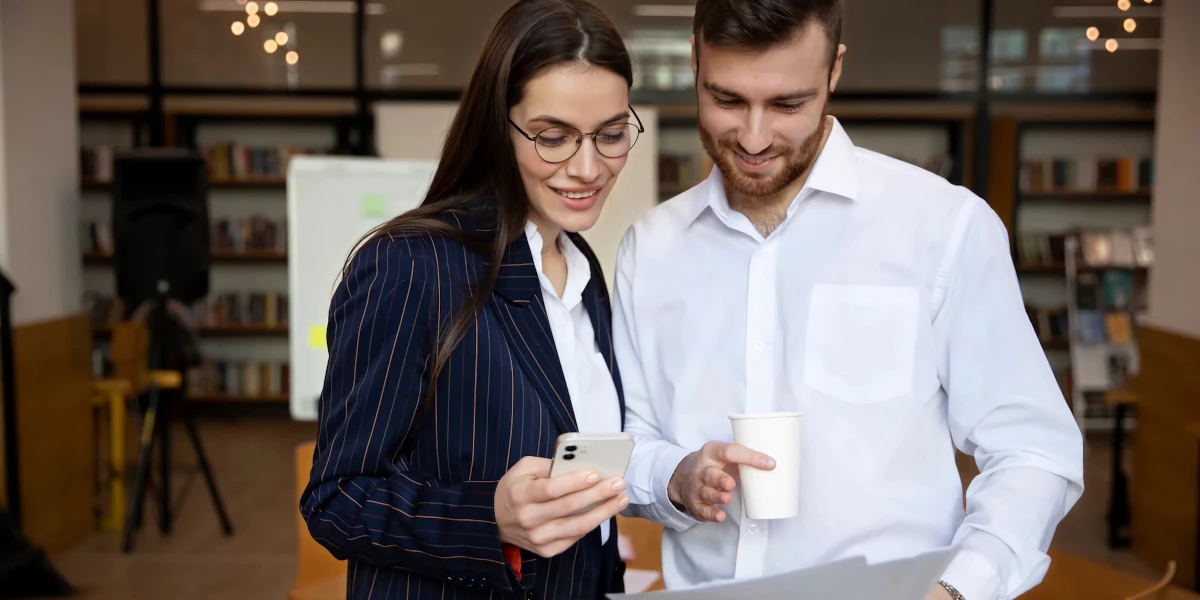 Coworker looking at a cell phone
