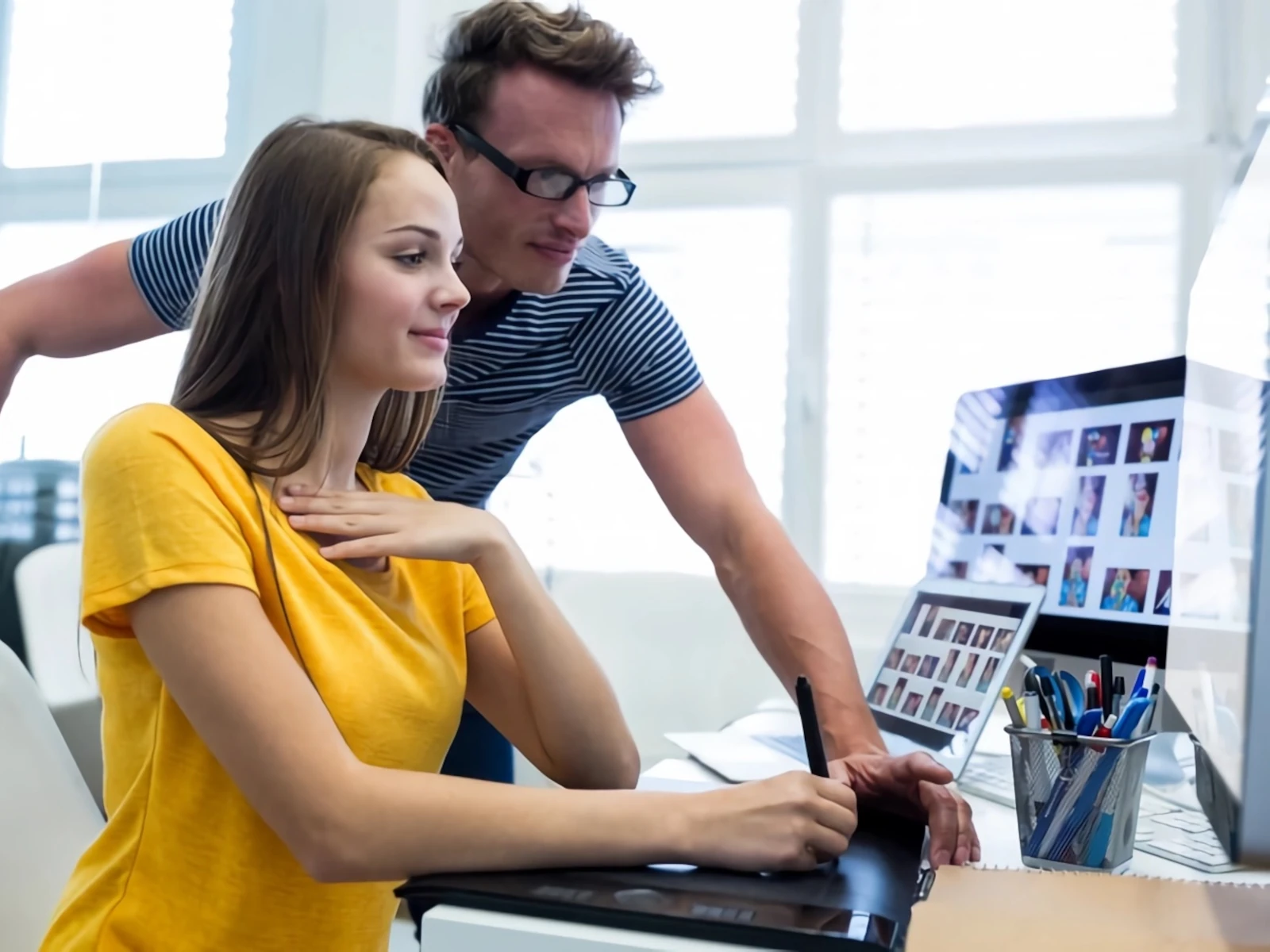Coworkers looking at a computer